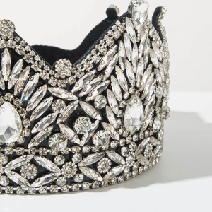 Macro detail of luxury baroque headband featuring shimmering crystals on black velvet base
