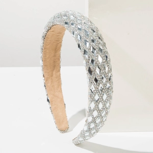 Close-up of wide headband with full diamond rhinestones and soft khaki fabric lining