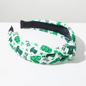 Detail of St. Patrick's Day headband with green shamrock and leprechaun hat patterns