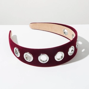 Detail of burgundy velvet headband featuring silver metal eyelets and a vintage design