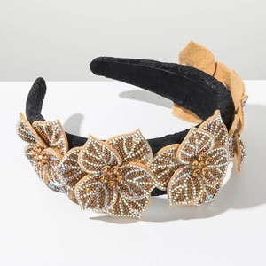 Close-up of baroque headband with five rhinestone-encrusted felt flowers and brown gems