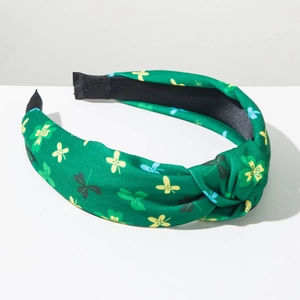 Close-up of green knotted headband with clover patterns for St. Patrick's Day celebration