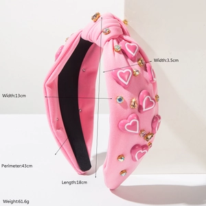 Roze geknoopte haarband met glinsterende hartjes en strass op een geometrische achtergrond