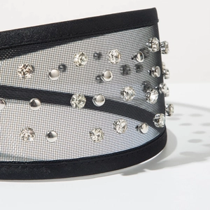 Detail of black tulle headband featuring sparkling rhinestones and silver metal studs