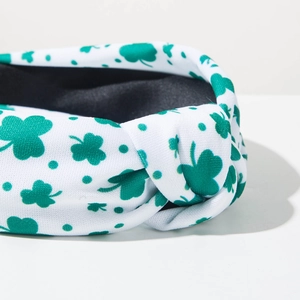 Detail of St. Patrick's Day headband showing green clover print and central knot design