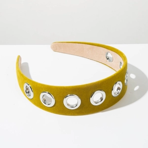 Detailed view of olive velvet headband featuring polished silver metallic eyelets and rivets