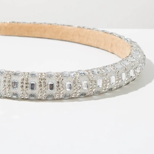 Macro shot of silver rhinestone padded headband with crystal embellishments and velvet lining