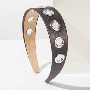 Detail of silk texture headband with metal eyelets and leopard pattern dark grain