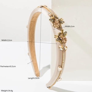 Baroque style gold headband with crystal bee embellishment on white display block