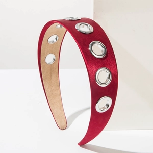 Detailed shot of red satin headband with silver metal eyelets and beige anti-slip inner lining