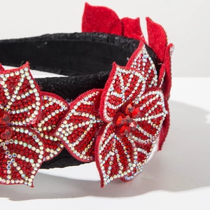 Macro shot of baroque style headband showing red petals with sparkling crystals