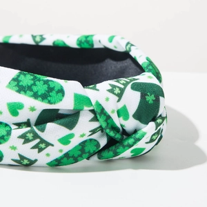 Detailed view of St. Patrick's Day knotted headband with clover and hat pattern print