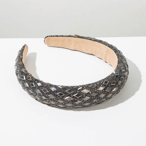 Detailed macro view of a dark grey wide headband fully encrusted with sparkling rhinestones