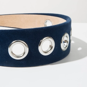 Macro detail of dark blue velvet headband featuring polished silver metal eyelets