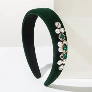 Detail of dark green velvet headband with baroque emerald gems and pearls ornamentation