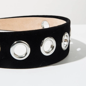 Detail of black velvet headband with silver metal grommets and smooth inner lining