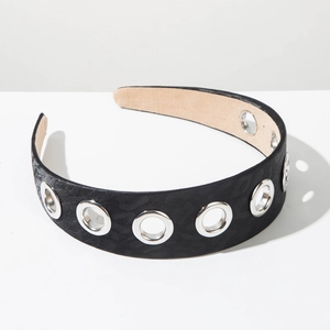 Close-up of wide black fabric headband with silver metal grommets and textured pattern