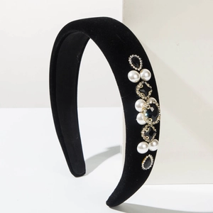 Detailed macro view of vintage Baroque velvet headband with pearls and rhinestones