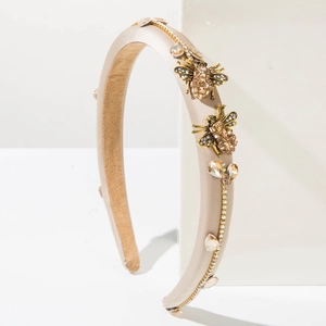 Detail of luxury baroque headband with gold bee ornaments and sparkling crystals