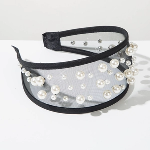 Detail view of black tulle headband with intricate pearl embellishments and wide band