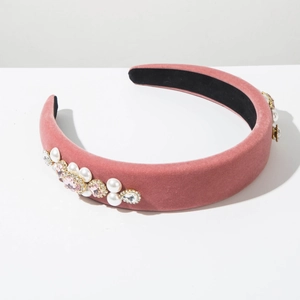 Detail of pink velvet headband with elegant pearls and sparkling rhinestones