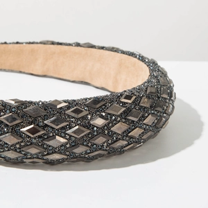 Close-up of wide padded headband with dark grey rhinestones and bead embellishments