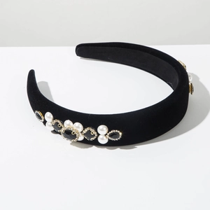Detail of black velvet headband with white pearls and faceted black gemstones