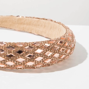 Close-up of padded headband with champagne gold rhinestones and anti-slip velvet lining