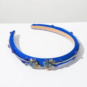 Detailed view of luxury navy blue satin headband with crystal bees and rhinestone accents