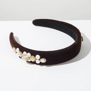 Detail of velvet padded headband with intricate champagne rhinestones and white pearls