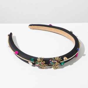 Detail view of Baroque headband with golden bees and colorful crystals on black fabric