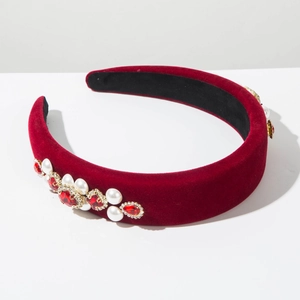 Detailed side view of velvet headband featuring red rhinestones and pearls