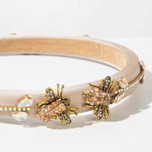 Close-up of vintage baroque headband with golden bee accents and sparkling crystals