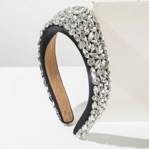 Macro view of Baroque style headband featuring intricate rhinestones on black fabric