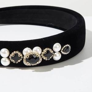 Macro view of black velvet headband with pearls and baroque crystal embellishments
