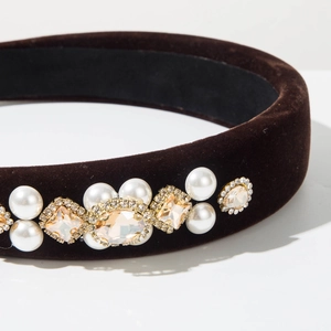 Macro detail of brown velvet headband with pearl and champagne gemstone embellishments
