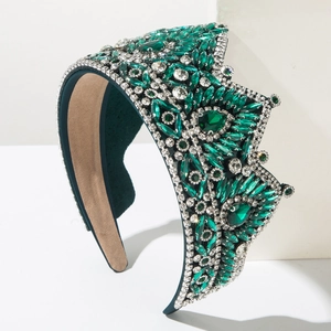 Green crystal baroque crown headband with emerald leaf patterns on white stand