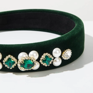 Detail of green velvet headband with pearls and emerald gems in French baroque style