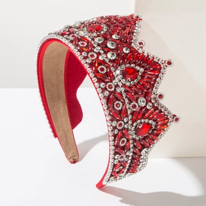 Close-up of luxury Baroque headband with red crystals and white diamonds on velvet