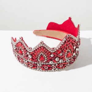 Macro shot of luxury Baroque crown headband with red rhinestones and silver crystal inlay