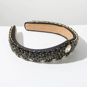 Close-up of luxury Baroque headband with black crystals and gold metal settings