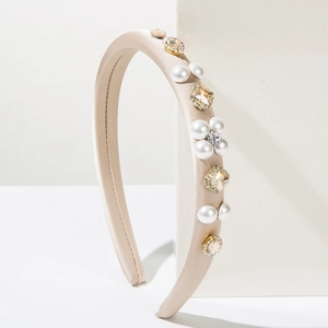 Elegant champagne satin headband with white pearls and sparkling rhinestone flower details
