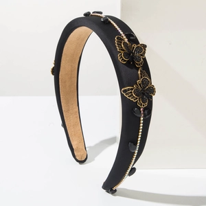 Elegant black padded headband with sparkling butterfly accents and colored crystals