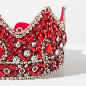 Detailed close-up of a baroque crown featuring luxury red crystals and silver alloy base