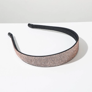 Close-up of rose gold rhinestone headband with sparkling pink crystals on black base