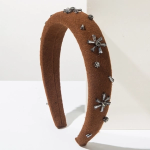 Detailed texture of caramel wool headband with grey crystal flowers on sponge base