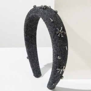 Detail of dark grey felt headband with hand-sewn crystal beads and rhinestones