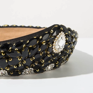 Detail of baroque headband with black marquise gems and white rhinestones on velvet