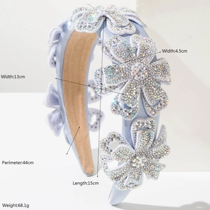 Light blue padded headband with five rhinestone-encrusted floral designs on white background