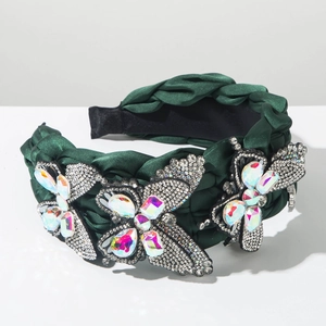 Detailed view of luxury dark green braided headband with sparkling rhinestone butterflies
